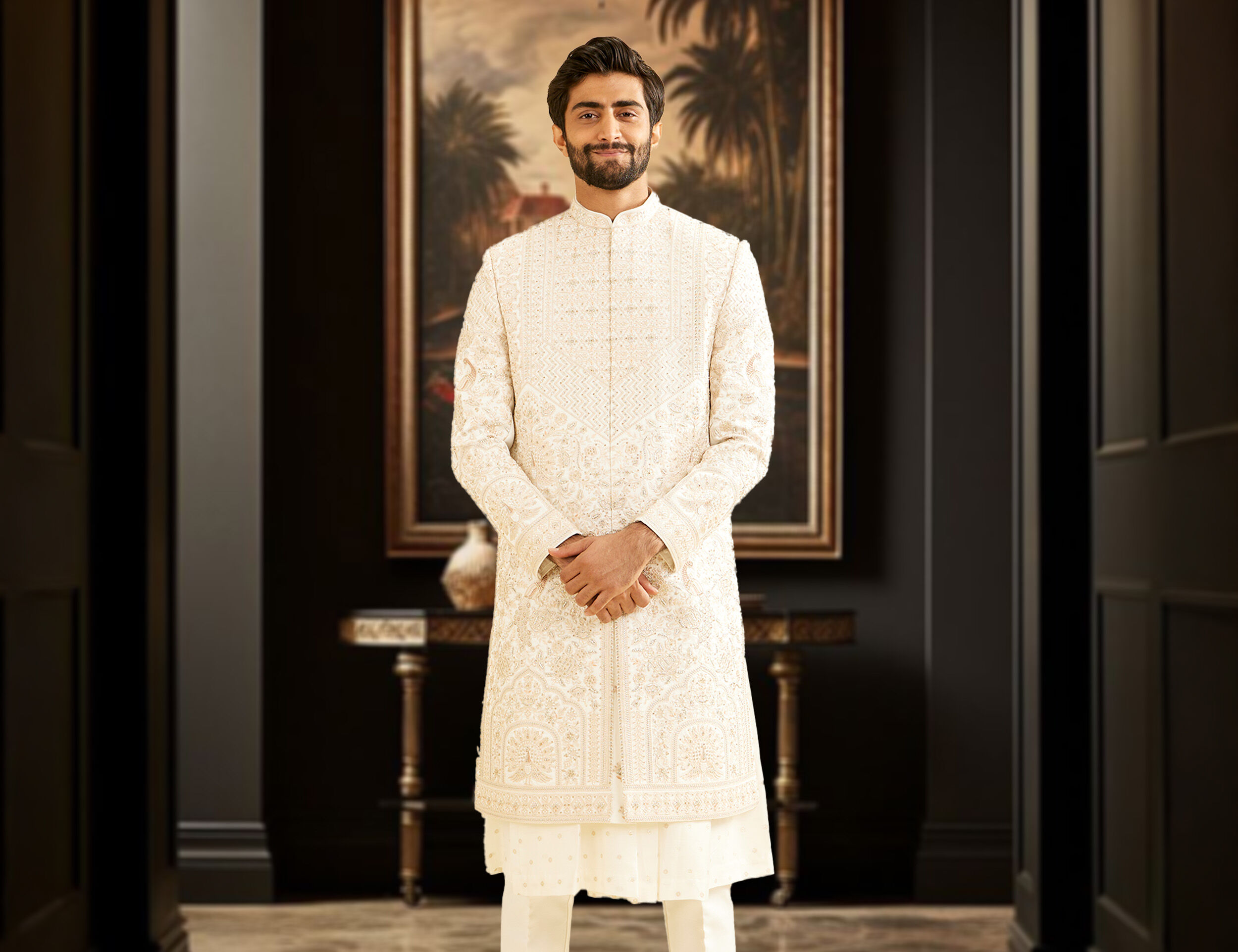 A groom in white sherwani for his wedding